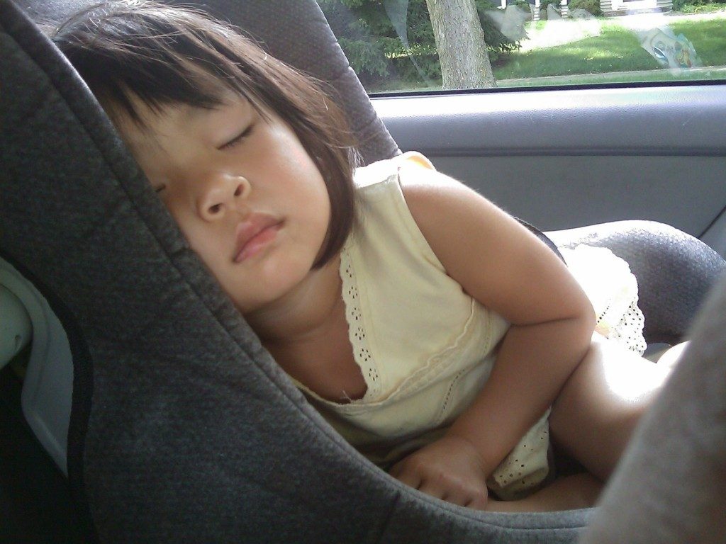 Little girl sleeping in car seat